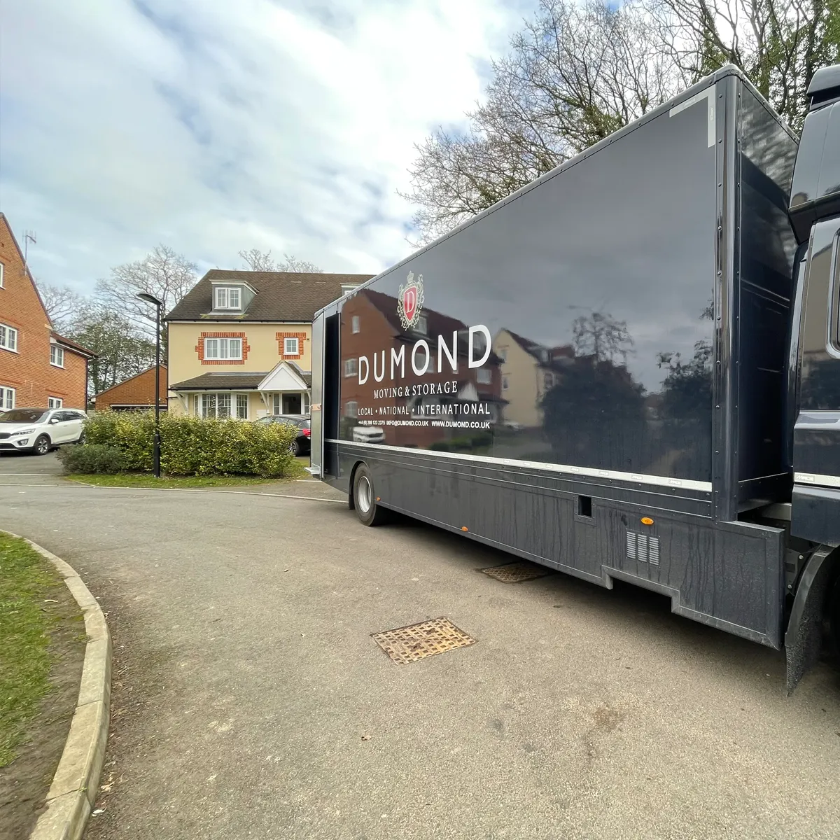 Professional removals van outside a residential property.