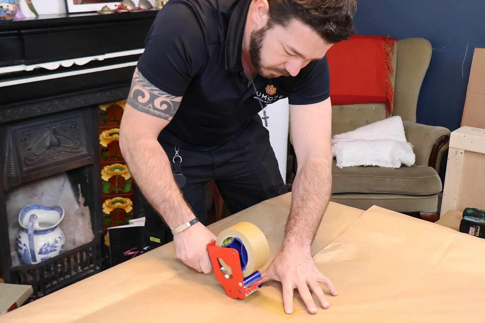 A Dumond employee packing items in a residential home