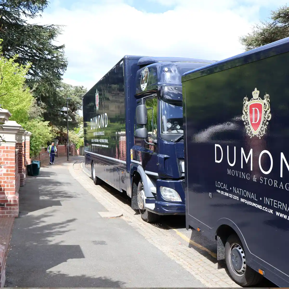 Two Dumond removals vans outside a residential property during a carefully managed move.
