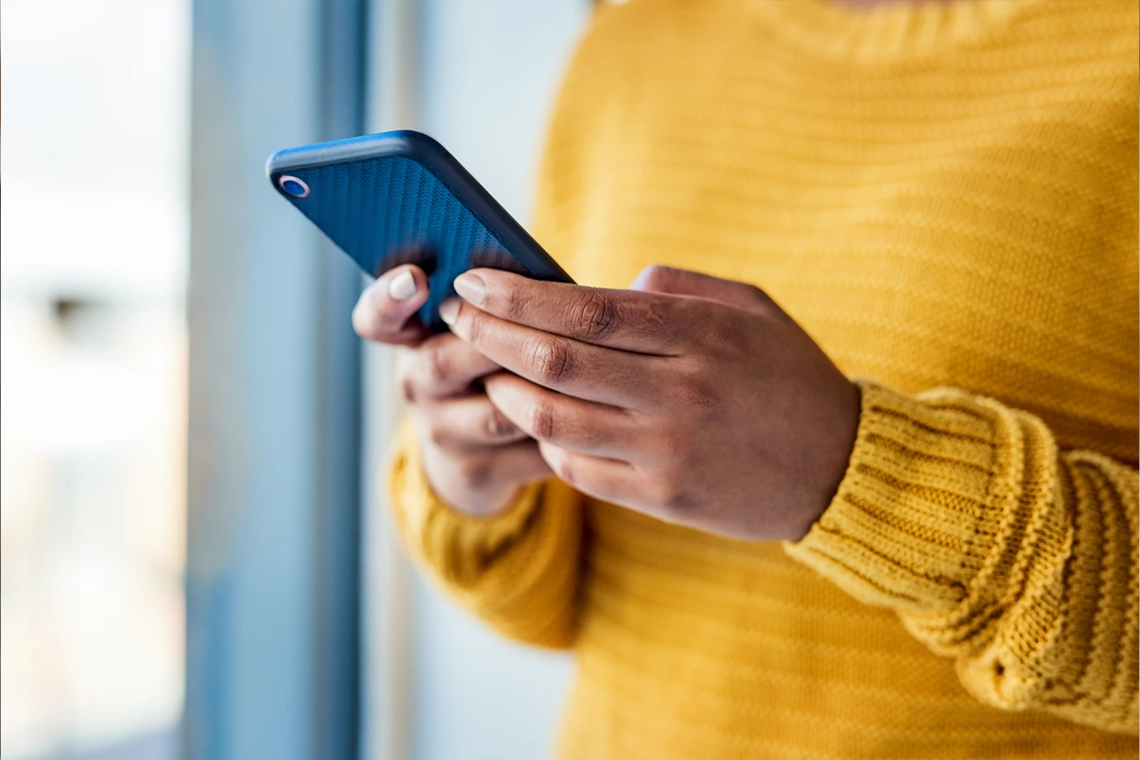 Hands using a mobile phone representing a single point of contact throughout the move.